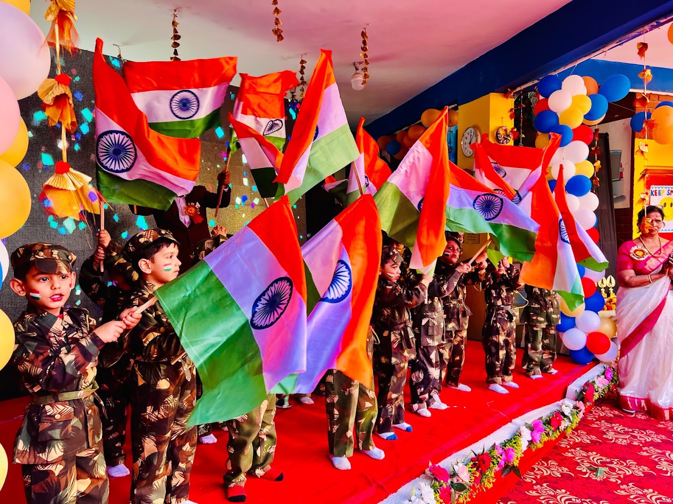 Children performing with flags on stage at Grandmaa's Preschool & DayCare, Greater Noida